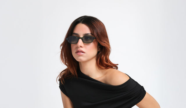 Woman in a black blouse wearing the Munich Sunglasses