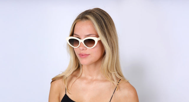 Woman with blonde hair wearing Pamela Sunglasses in Cream with Brown Gradient