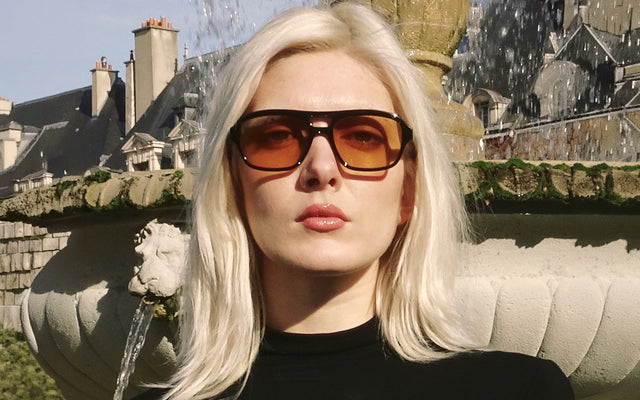 Woman in Paris wearing the Queens Sunglasses near a fountain
