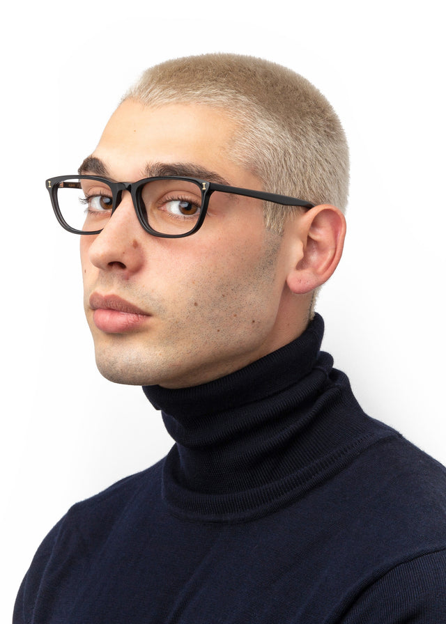 Side profile of model with blonde buzzcut wearing Albany Optical Black Optical