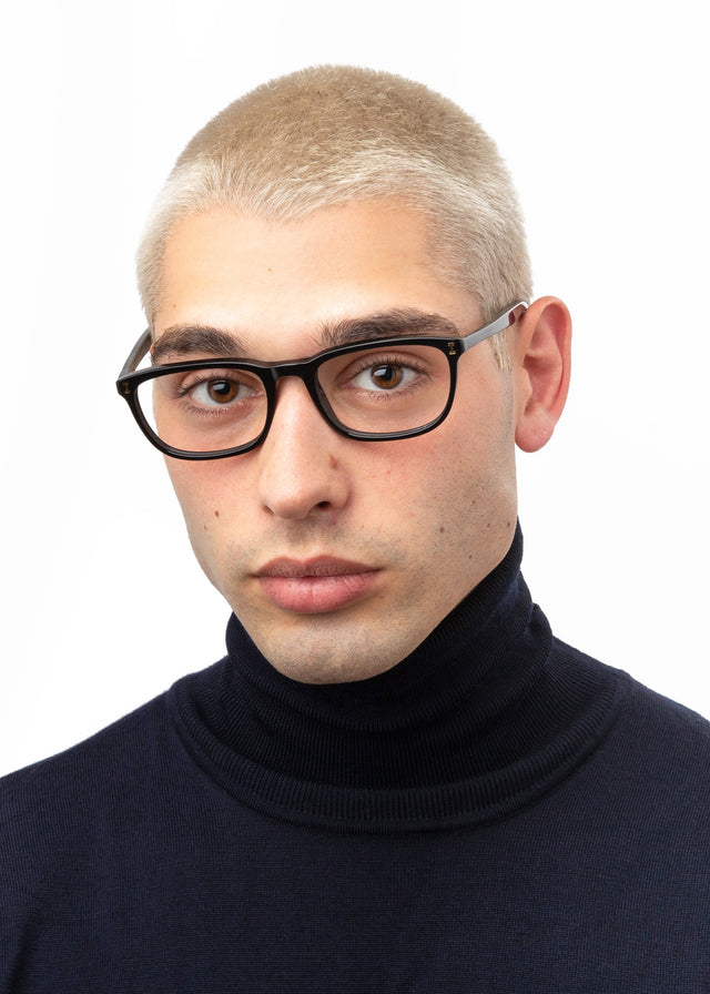 Model with blonde buzzcut wearing Albany Optical Black Optical