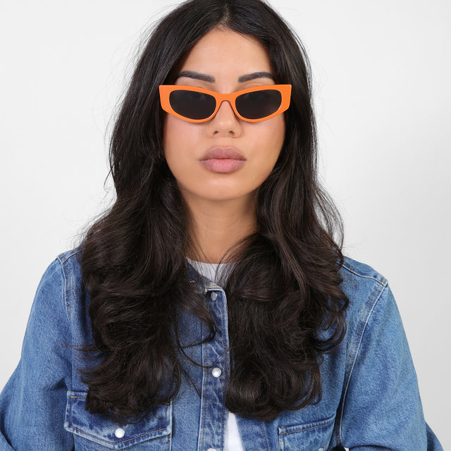 Brunette model in denim wearing Alexa Sunglasses Aperol with Grey Flat