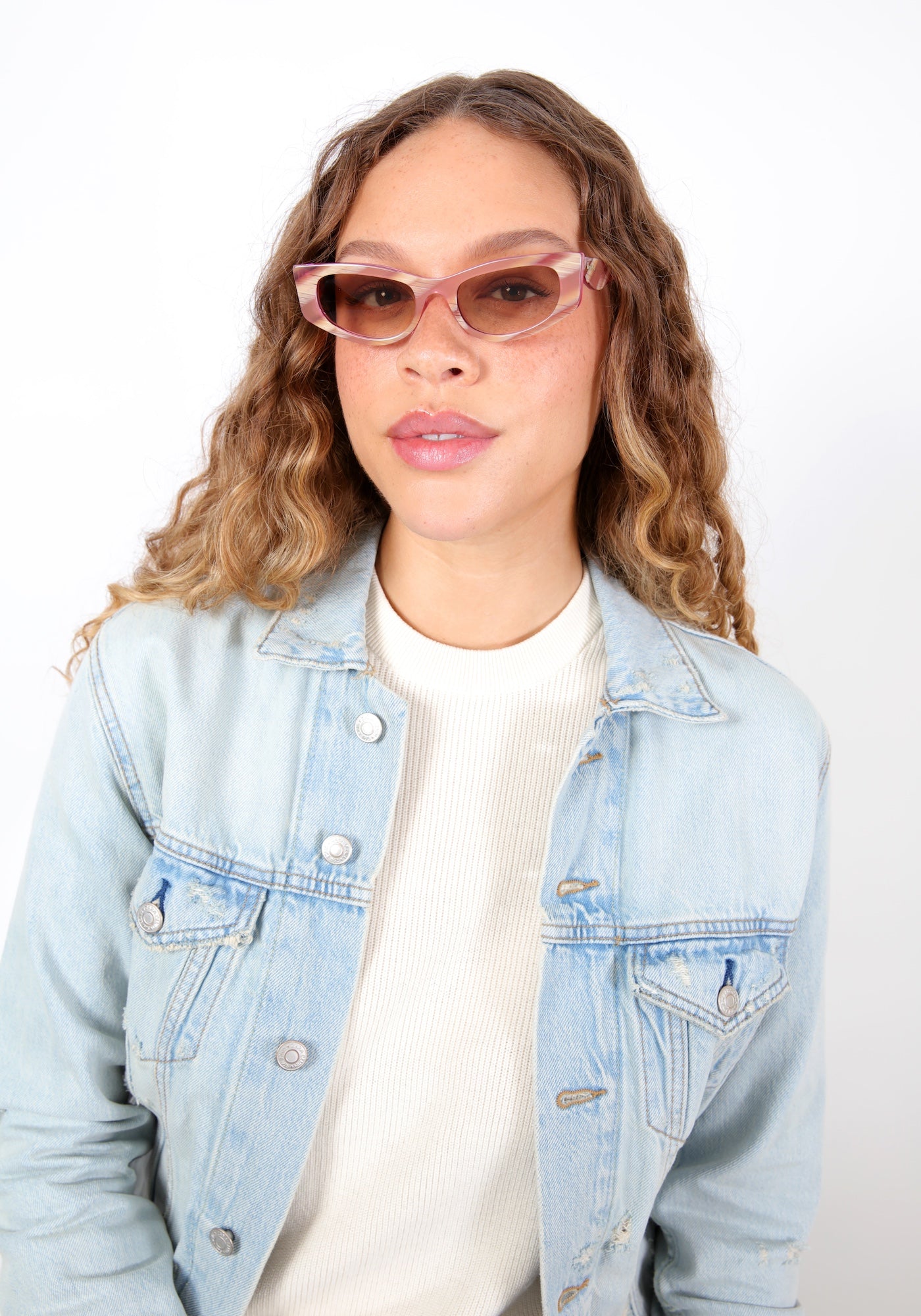 Brunette model with ombré curls wearing Alexa Sunglasses in Monte Rosa