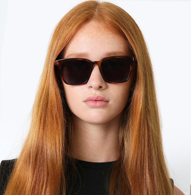 Model with straight red hair wearing Asheville Sunglasses Havana with Grey
