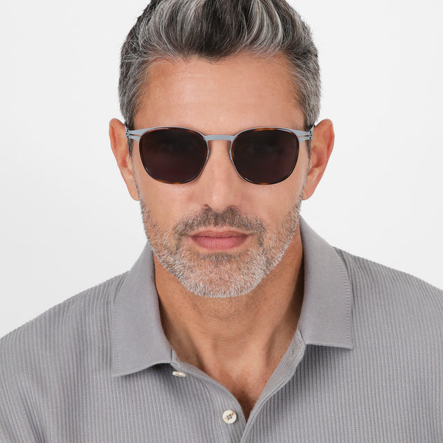 Model with salt and pepper hair and beard wearing Astor Titanium Sunglasses Havana/Matte Gunmetal with Grey