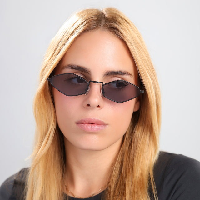 Another angle of blond woman in a black tee wearing Astoria Sunglasses Matte Black with Grey Flat