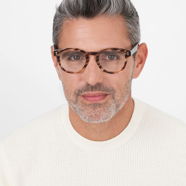 Model with salt and pepper hair and beard wearing Atlantic Optical Sand Dune Optical