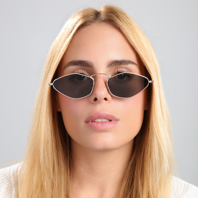Blond woman in a tee wearing Austria Sunglasses Gold with Grey Flat