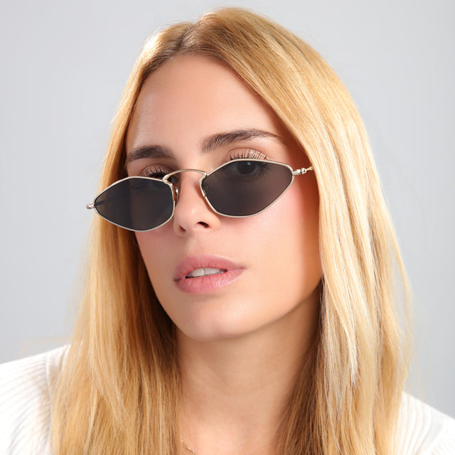 Another angle of blond woman in a tee wearing Austria Sunglasses Gold with Grey Flat