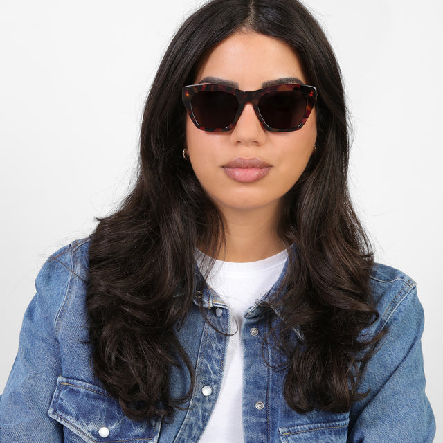 Brunette model in a denim jacket wearing Bali Sunglasses Havana with Brown