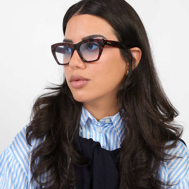 Brunette model in a blue and white striped blouse looking right wearing Bali Sunglasses Violet Havana with Blue Gradient See Through