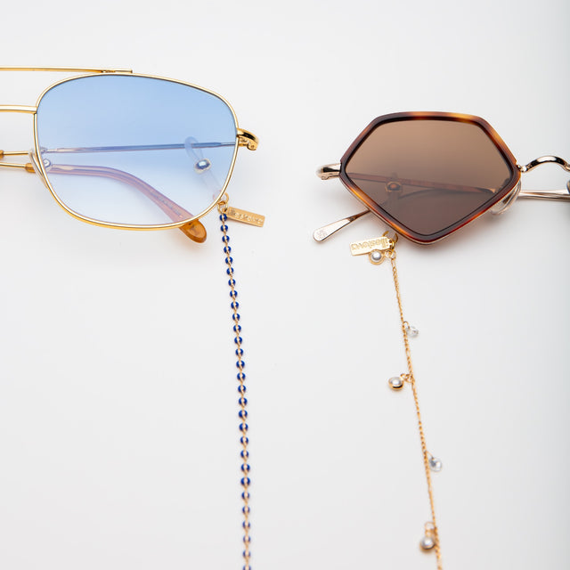 The Beak Ace 53 Sunglasses with the sunglass chain attached next to another frame with Barbados attached  Margarita