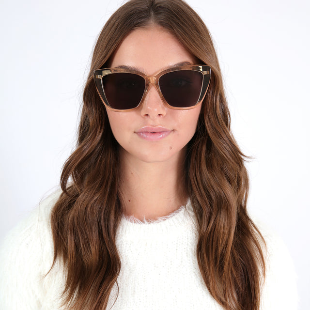 Brunette model with curled hair wearing Barcelona Sunglasses Citrine with Grey Flat