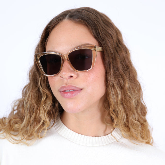Brunette model with ombré, wavy hair wearing Barcelona Sunglasses Citrine with Grey Flat 