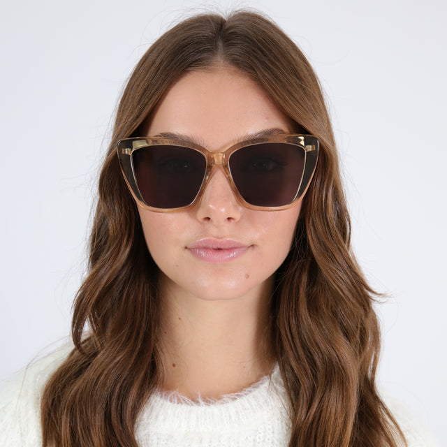 Brunette model with curled hair wearing Barcelona Sunglasses Citrine with Grey Flat 