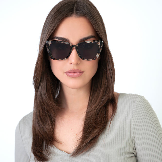 Brunette woman with straight hair wearing Barcelona Sunglasses White Tortoise with Grey Flat