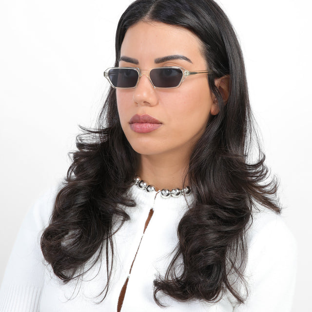 Brunette model with loose curls wearing Baxter Sunglasses Champagne with Grey