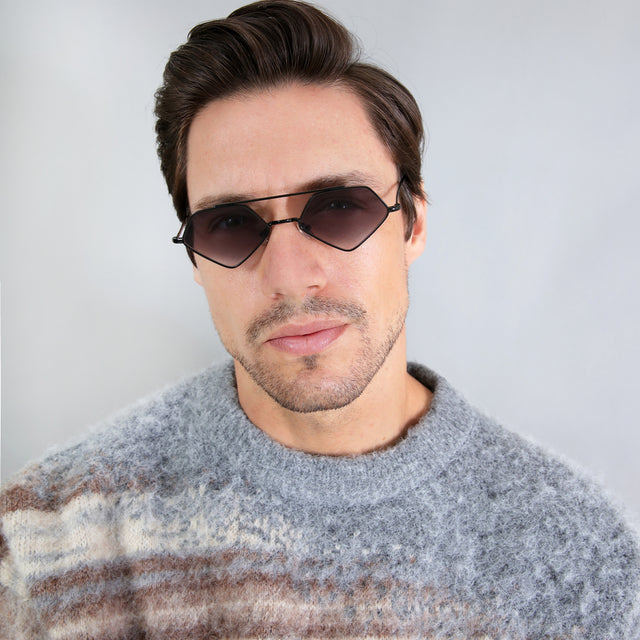 Model with short hair combed sideways wearing Bayley Sunglasses Black with Grey Flat Gradient