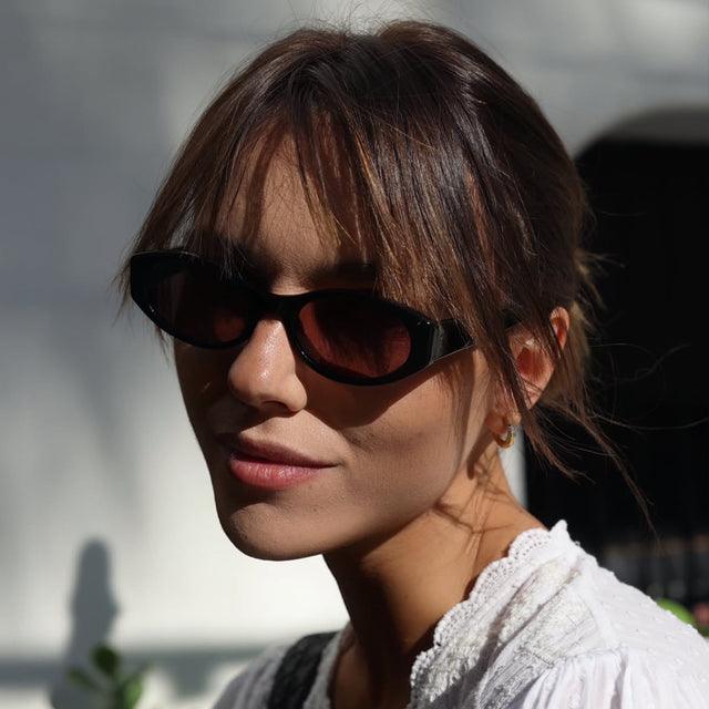 Woman outside near a spanish style casa wearing Bedford Sunglasses Black with Grey Gradient