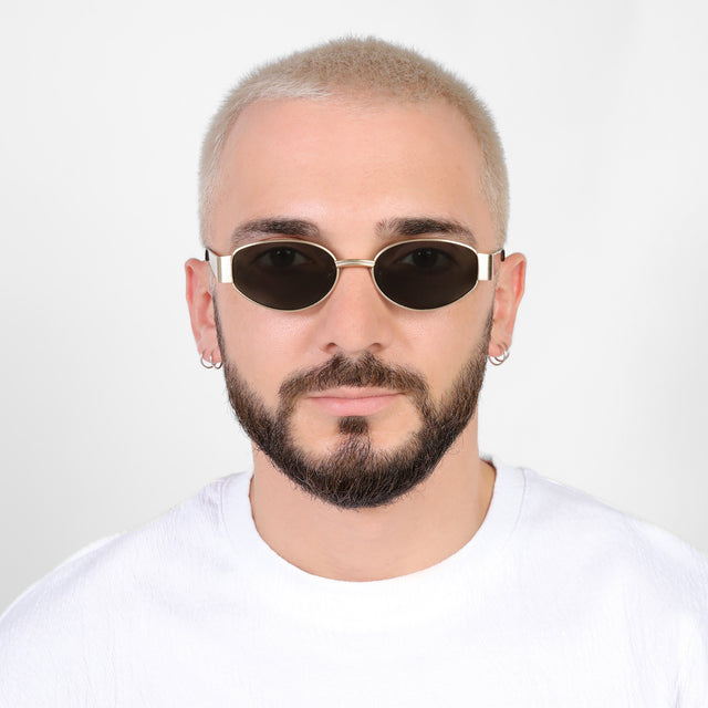 Model with a platinum buzzcut wearing Bellagio Sunglasses Brushed Gold with Grey