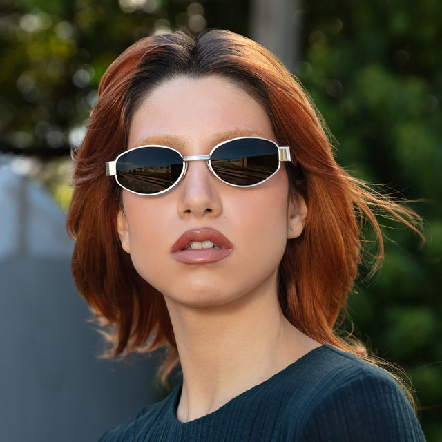 Red-haired model wearing Bellagio Sunglasses Brushed Gold with Grey