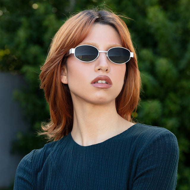 Red-haired model looking left wearing Bellagio Sunglasses Brushed Gold with Grey