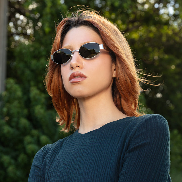 Another angle of red-haired model wearing Bellagio Sunglasses Brushed Gold with Grey