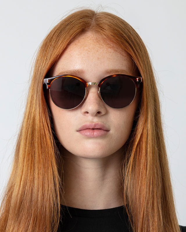 Model with straight red hair wearing Benson Sunglasses Havana Gold with Grey