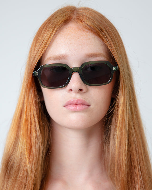 Model with straight red hair wearing Berlin Sunglasses Pine with Grey