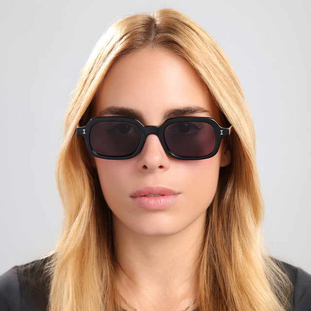 Blonde woman in a black tee wearing Berlin Sunglasses Black with Grey