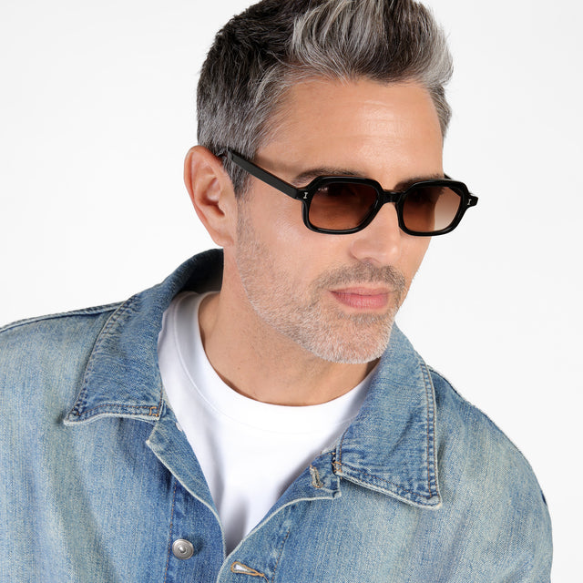 Male model looking left wearing Berlin Sunglasses Black with Brown Gradient