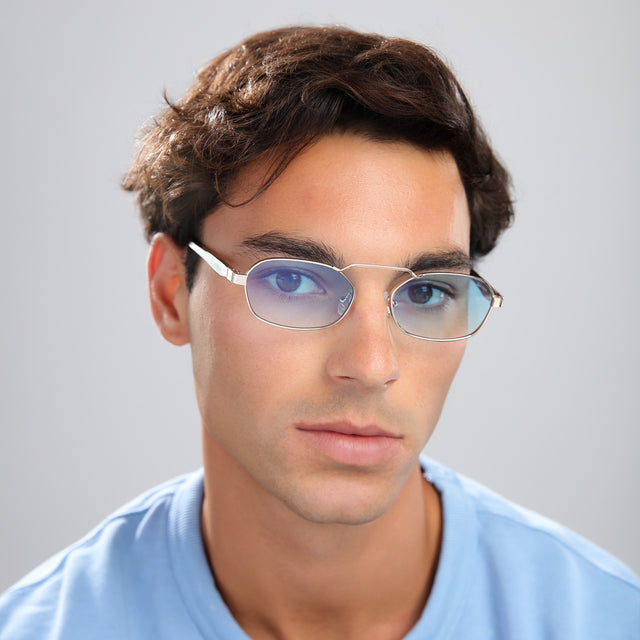Man with brown hair in a blue tee wearing Bimini Sunglasses Gold/Havana with Blue Flat Gradient See Through