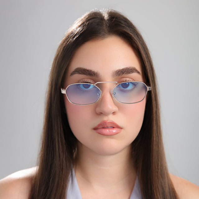 Brunette woman in a gray blouse wearing Bimini Sunglasses Gold/Havana with Blue Flat Gradient See Through