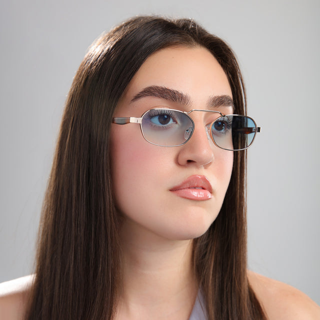 Another angle of brunette woman in a gray blouse wearing Bimini Sunglasses Gold/Havana with Blue Flat Gradient See Through