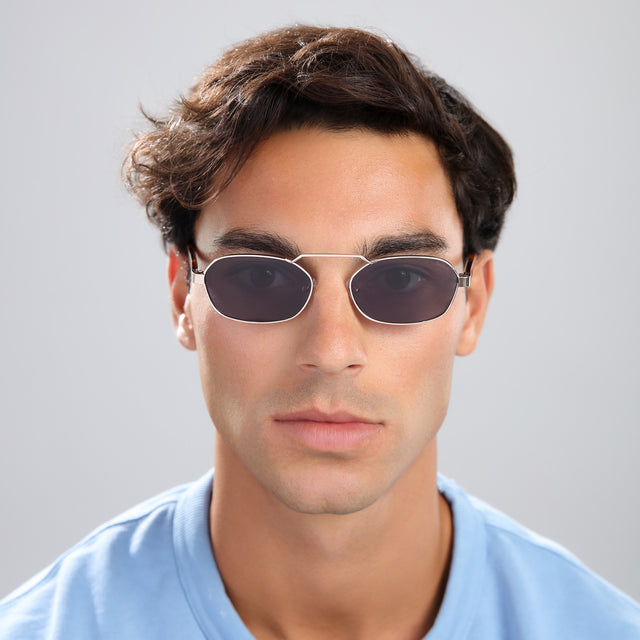 Man with brown hair in a blue tee wearing Bimini Sunglasses Gold/Havana with Grey Flat