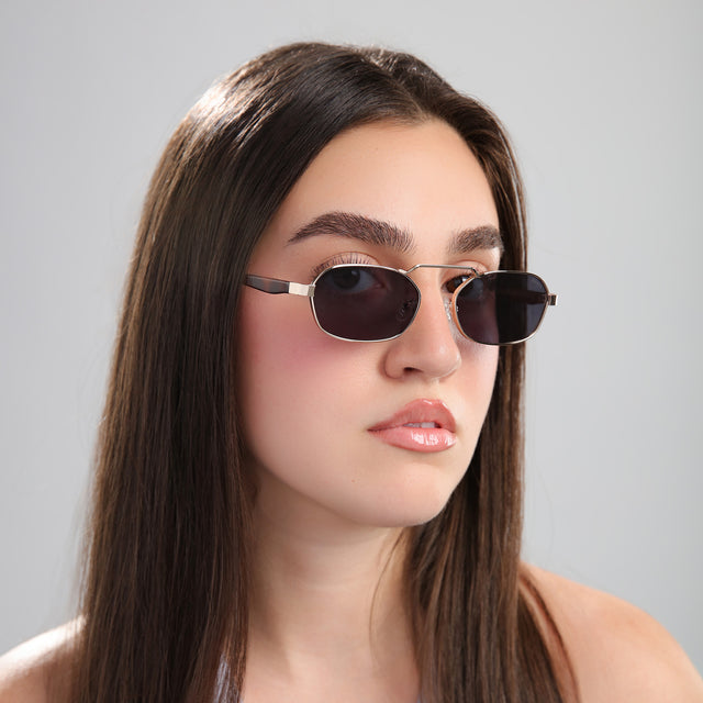 Another angle of brunette woman in a gray blouse wearing Bimini Sunglasses Gold/Havana with Grey Flat