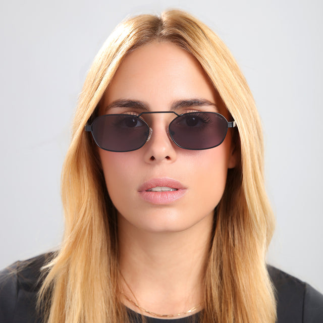Blond woman in a black tee wearing Bimini Sunglasses Matte Black with Grey Flat