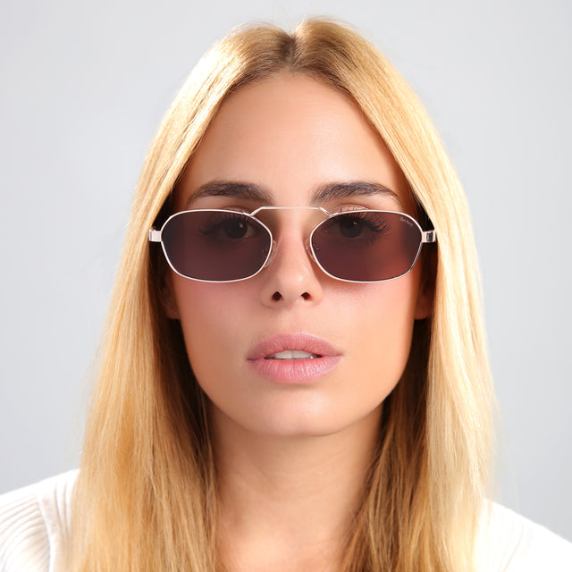 Blond woman in a white tee wearing Bimini Sunglasses Rose Gold/Havana with Brown Flat