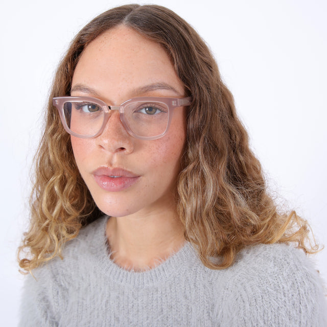 Brunette model with ombré, curled hair wearing Bobby Optical Thistle/Rose Gold Optical