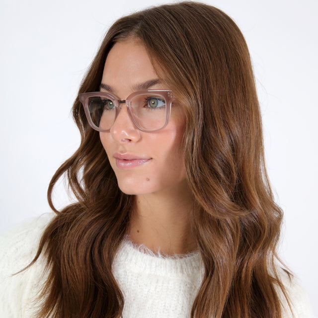 Brunette model with loose curls wearing Bobby Optical Thistle/Rose Gold Optical