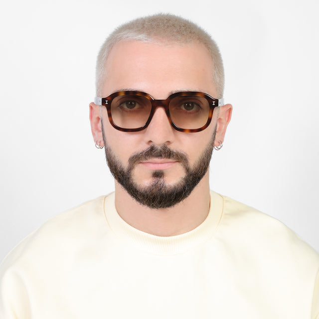 Model with a platinum buzzcut wearing Bogota E Sunglasses Bengal with Taupe Flat Gradient