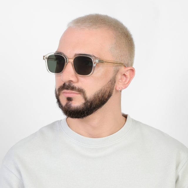 Bearded model looking right wearing Bogota E Sunglasses Champagne with Olive Flat