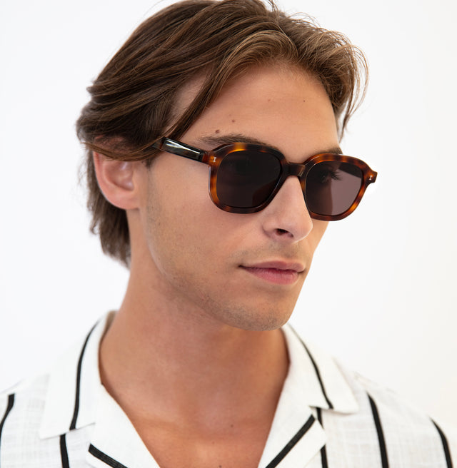 Model with semi short brown hair wearing Bogota Sunglasses Havana with Brown Flat