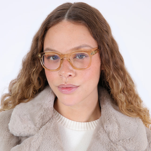 Brunette model with ombré, wavy hair wearing Boston Optical Citrine Optical