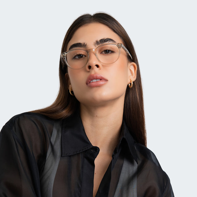 Woman in a sheer black blouse wearing Bristol Optical Cool Grey Optical