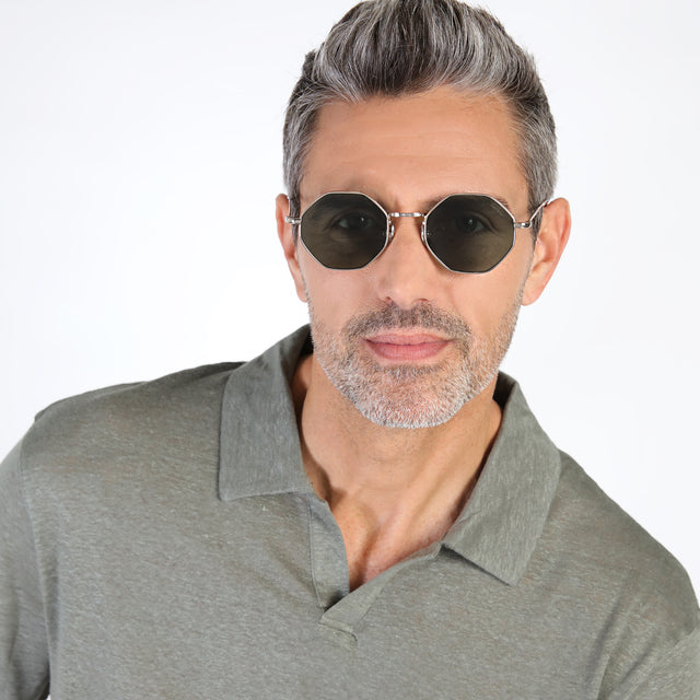 Model with salt and pepper hair and beard  wearing Broome Sunglasses Gold with Olive Flat