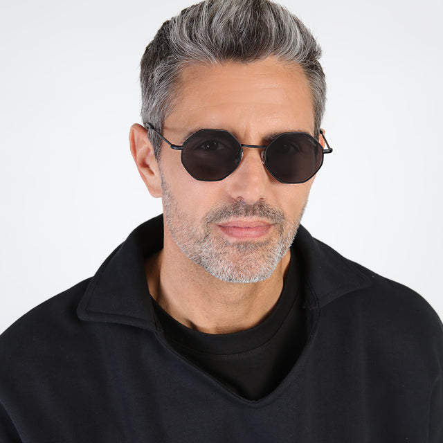 Model with salt and pepper hair and beard wearing Broome Sunglasses Matte Black with Grey Flat