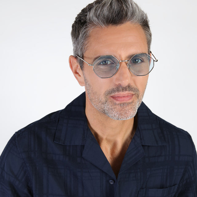 Model with salt and pepper hair and beard wearing Broome Sunglasses Silver with Light Blue Flat See Through