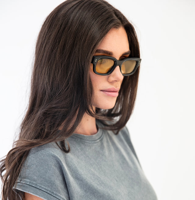 Brunette model in distressed T shirt wearing Cali Sunglasses Black with Honey See Through