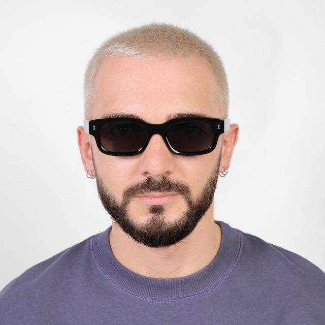 Model with a platinum buzzcut wearing Cali E Sunglasses Black with Grey